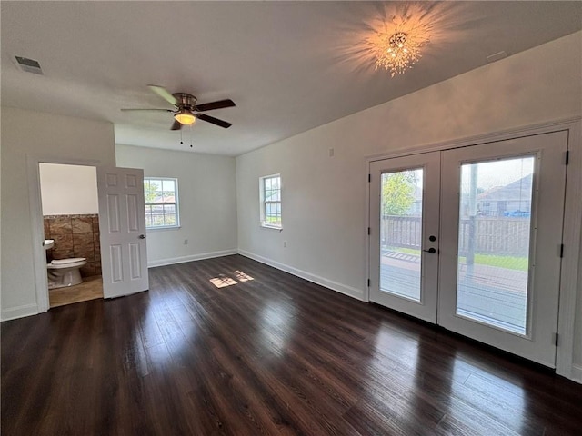 interior space featuring french doors, visible vents, dark wood-type flooring, a ceiling fan, and baseboards