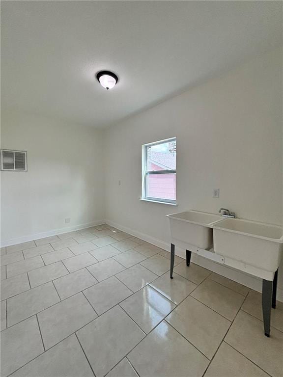 spare room with visible vents, baseboards, and light tile patterned flooring