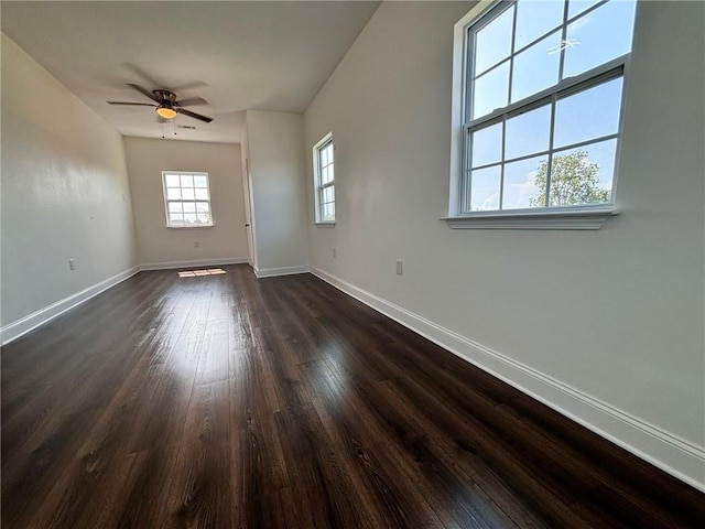 interior space with dark wood finished floors, baseboards, and ceiling fan