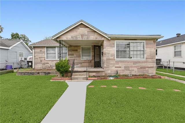 bungalow-style house featuring a front lawn