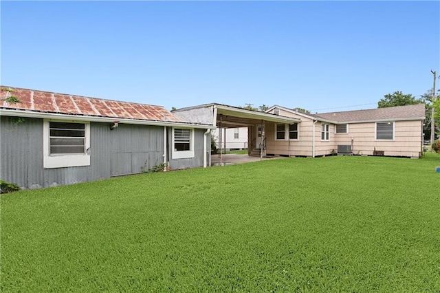 back of property featuring a patio, a yard, and central air condition unit