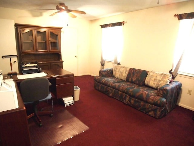 office space featuring ceiling fan and dark carpet