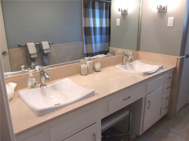 bathroom featuring tile patterned flooring and vanity