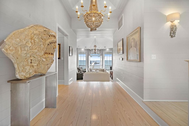 hallway featuring a chandelier and light wood-type flooring