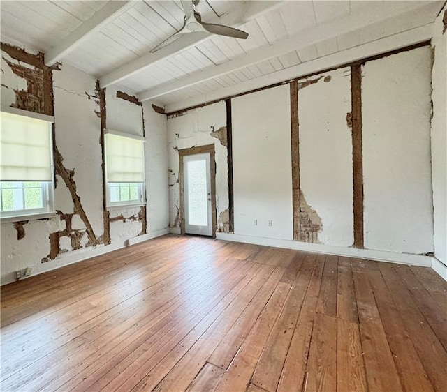 spare room with ceiling fan, beam ceiling, and hardwood / wood-style floors