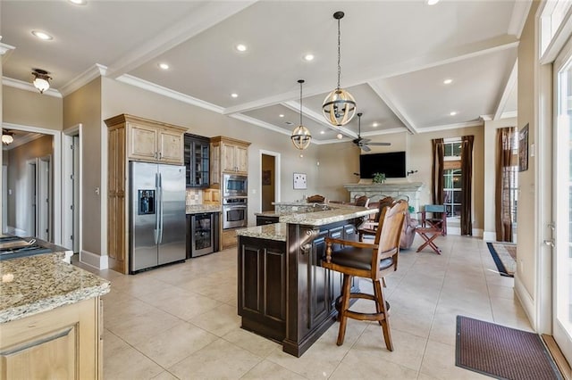 kitchen with wine cooler, open floor plan, a breakfast bar, light tile patterned floors, and appliances with stainless steel finishes