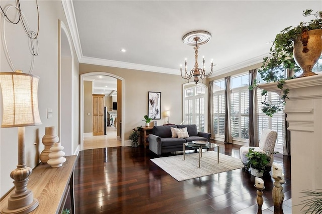 living room with crown molding, hardwood / wood-style flooring, and a notable chandelier