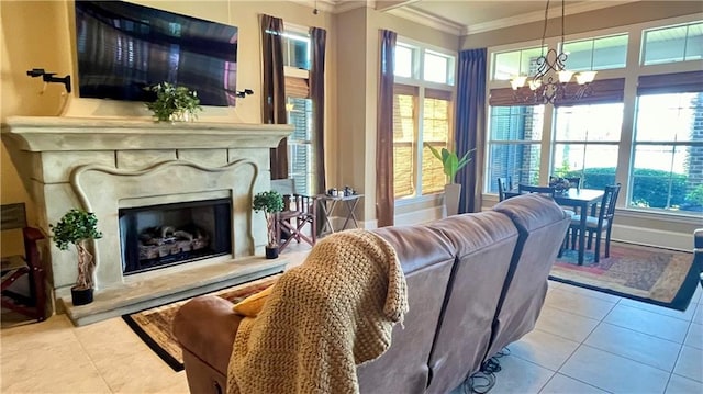 living room with a stone fireplace, ornamental molding, light tile patterned floors, and a chandelier