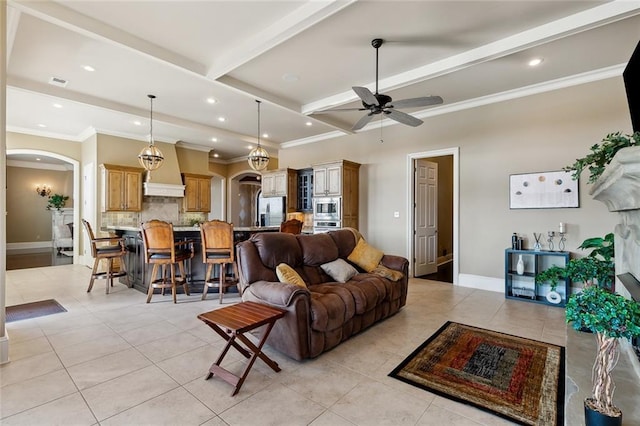 living room with beamed ceiling, light tile patterned floors, visible vents, and arched walkways