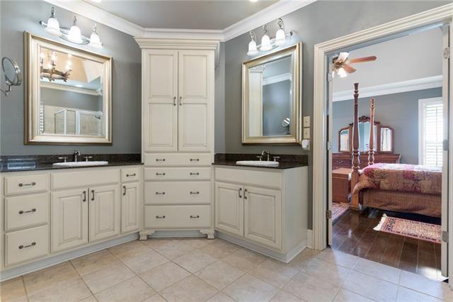 ensuite bathroom with ensuite bath, tile patterned flooring, vanity, and crown molding