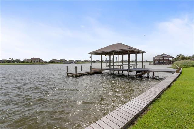 dock area with a yard and a water view