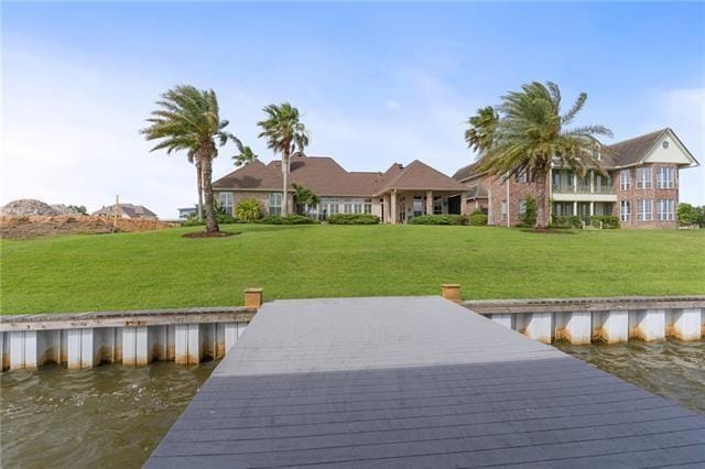 dock area featuring a lawn and a water view