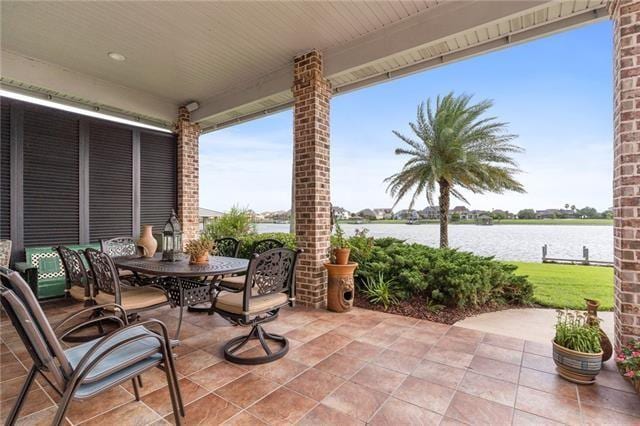 view of patio featuring outdoor dining area and a water view