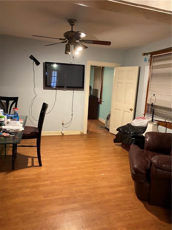 8836 Forshey St, New Orleans, LA 70118 - living room with a ceiling fan, light wood-style floors, and baseboards
