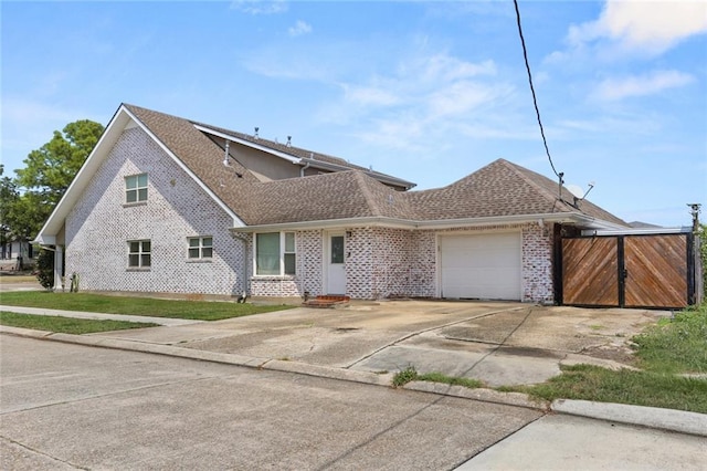 view of front of house featuring driveway, brick siding, an attached garage, and a shingled roof