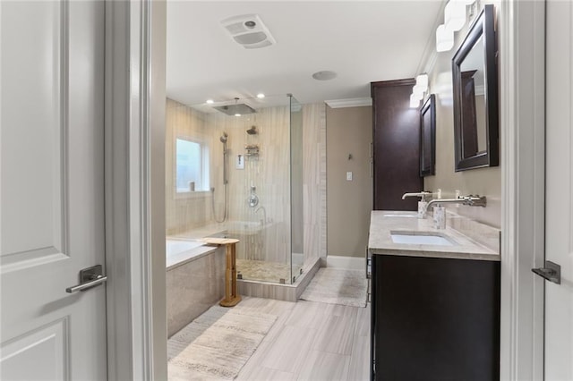 bathroom featuring double vanity, a stall shower, baseboards, a garden tub, and a sink