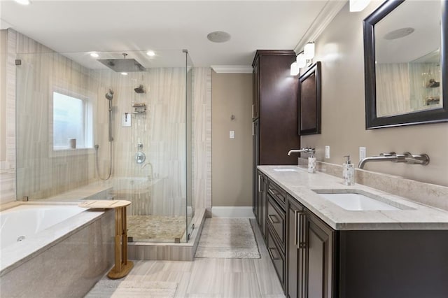 full bathroom featuring crown molding, a sink, a shower stall, and double vanity