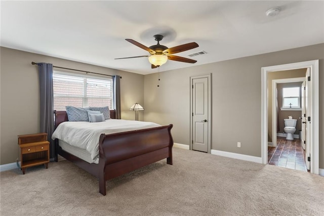 carpeted bedroom featuring visible vents, baseboards, and multiple windows