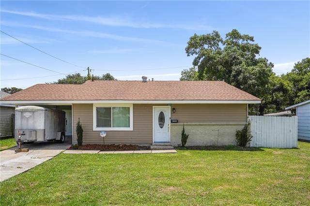 ranch-style home featuring a carport and a front yard