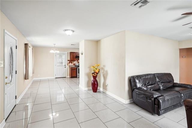 living room featuring ceiling fan and light tile patterned floors