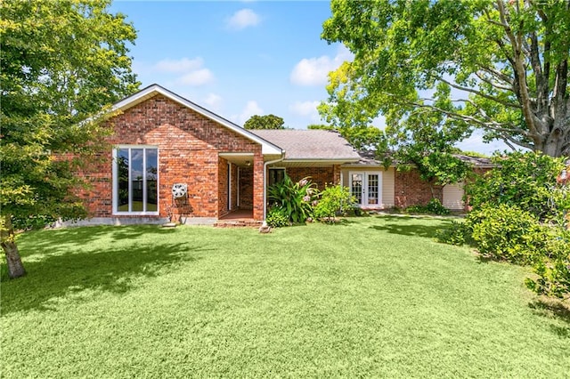 rear view of property with a lawn