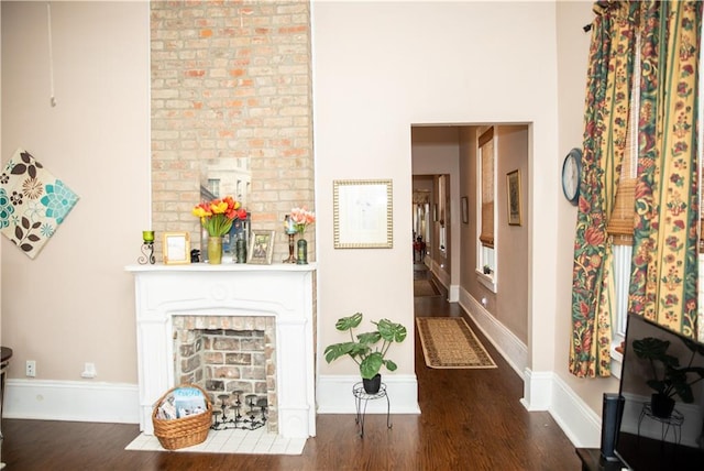 interior space with a fireplace and dark hardwood / wood-style flooring