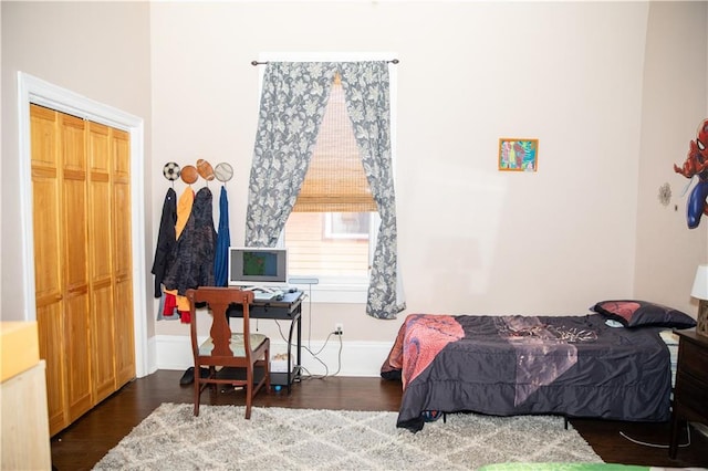 bedroom featuring a closet and dark wood-type flooring