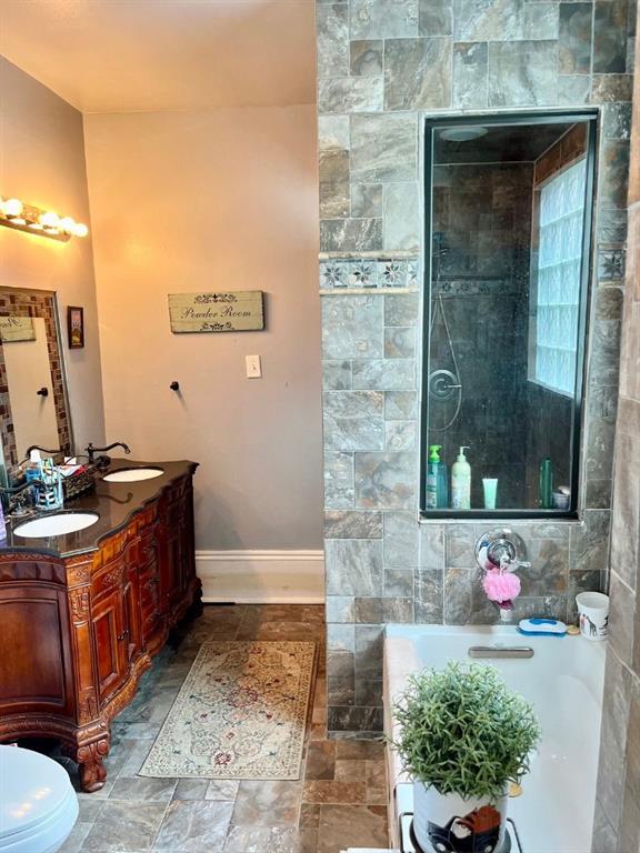 bathroom featuring vanity and toilet