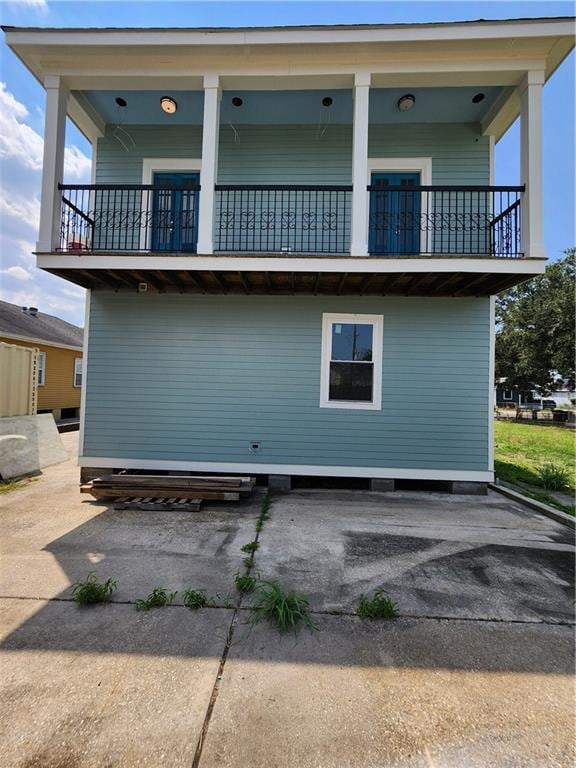 rear view of property with a balcony