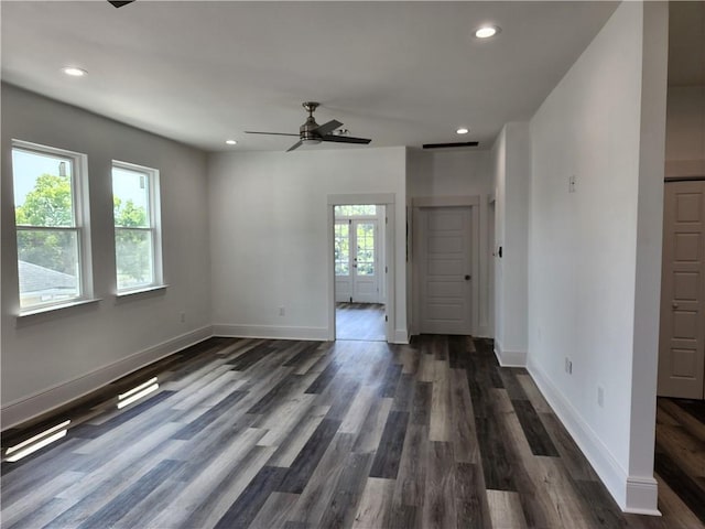 unfurnished room featuring ceiling fan, hardwood / wood-style floors, and a healthy amount of sunlight