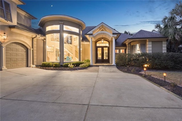 view of front facade with french doors and a garage