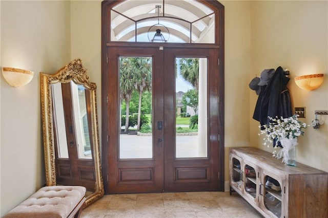 foyer entrance featuring french doors and vaulted ceiling