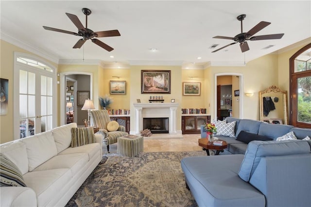 living room with ceiling fan and ornamental molding