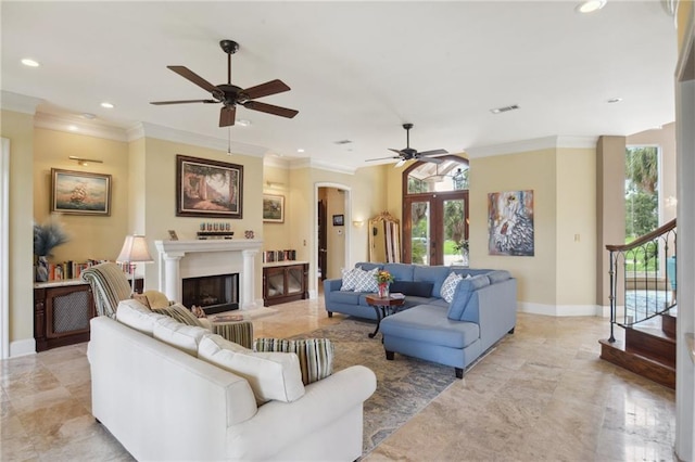 living room featuring ceiling fan and ornamental molding