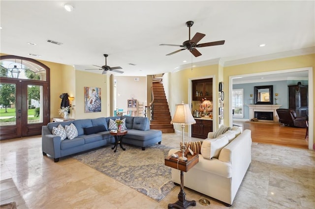 living room with ceiling fan and crown molding