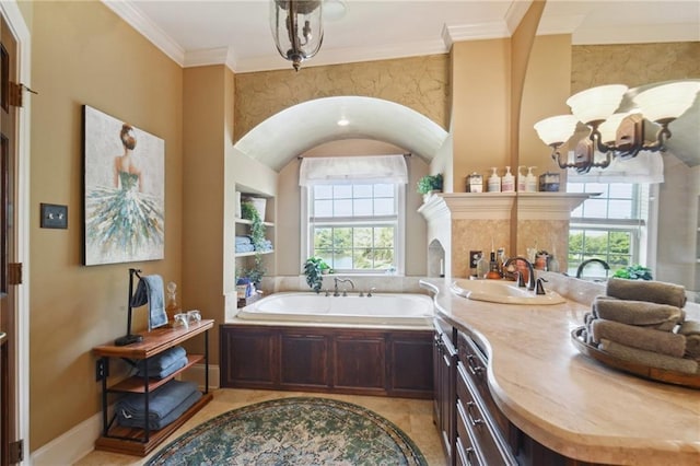 bathroom featuring tile patterned flooring, vanity, a healthy amount of sunlight, and a tub