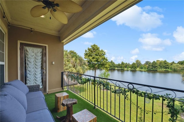 balcony featuring a water view and ceiling fan