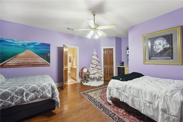 bedroom featuring ceiling fan, wood-type flooring, and ensuite bath