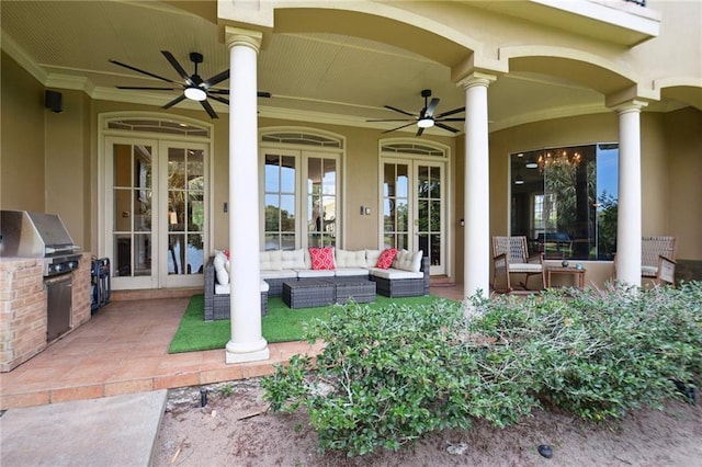 view of patio / terrace featuring outdoor lounge area, ceiling fan, a grill, and an outdoor kitchen