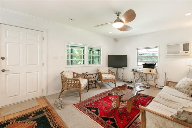 living room with ceiling fan, a wealth of natural light, light colored carpet, and an AC wall unit