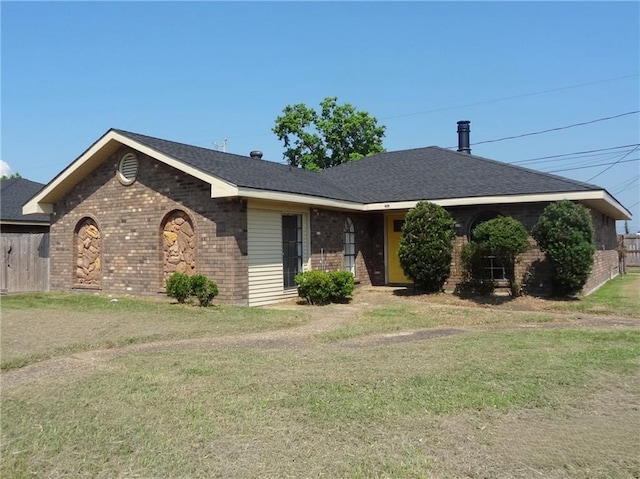 ranch-style house featuring a front yard and brick siding