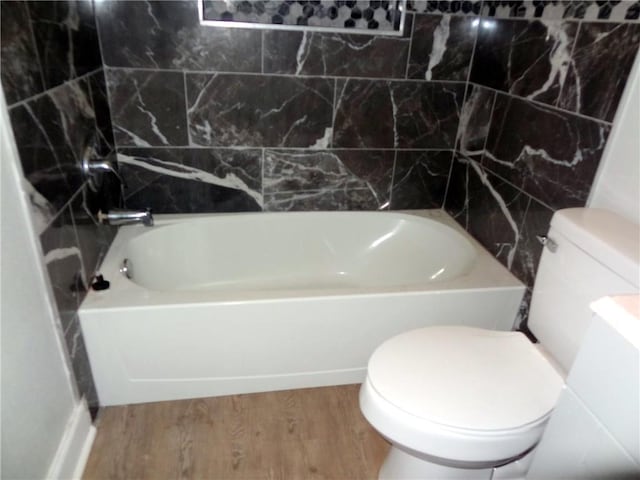 bathroom featuring  shower combination, wood finished floors, and toilet