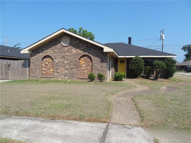 single story home with brick siding, a front yard, and fence