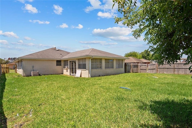 back of house featuring a lawn