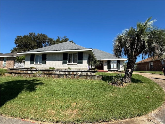 ranch-style house featuring a front lawn