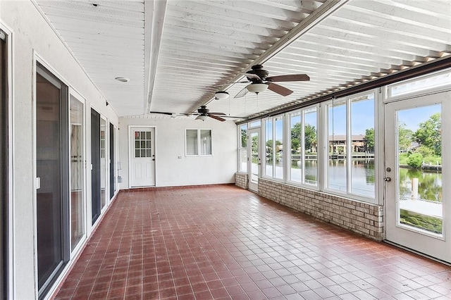 kitchen with a center island, built in appliances, tasteful backsplash, vaulted ceiling with beams, and exhaust hood