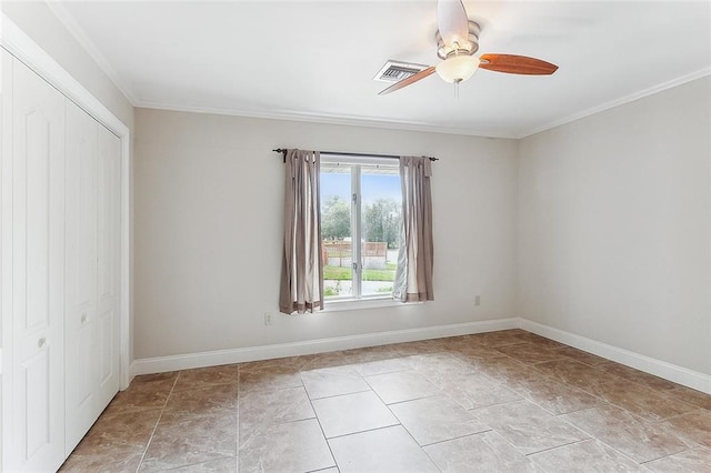 empty room featuring crown molding and ceiling fan