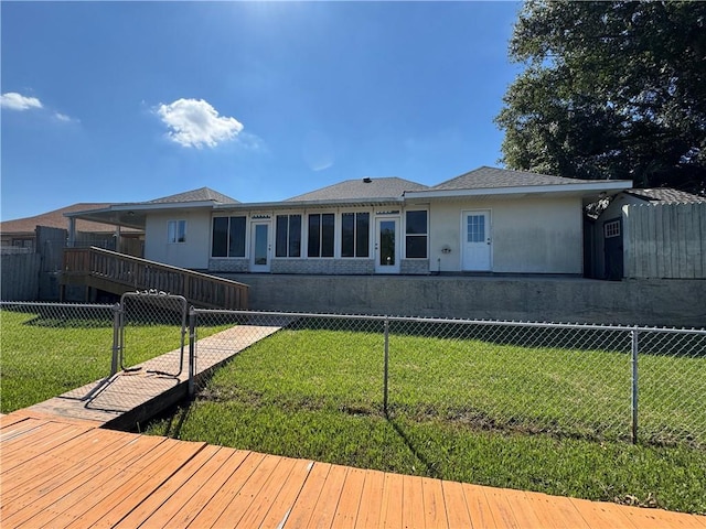 back of house featuring a yard and a wooden deck