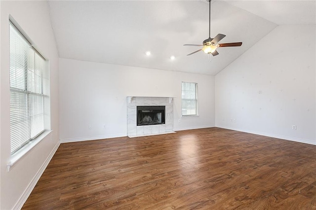 unfurnished living room with lofted ceiling, a fireplace, dark wood-type flooring, and ceiling fan