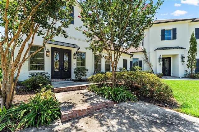 mediterranean / spanish-style home featuring french doors